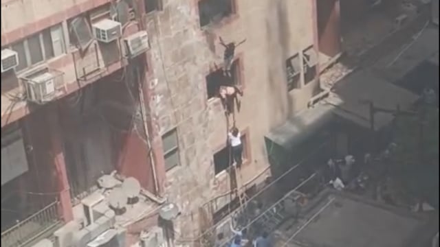 A screengrab from CCTV footage shows people jumping out of the windows in Noida Sector 18. (HT Photo)