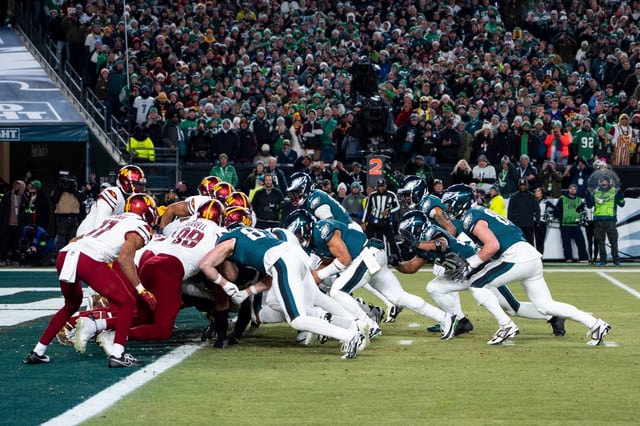 Philadelphia Eagles quarterback Jalen Hurts (1) lines up for the goal line Tush Push play during the NFL championship playoff football game against the Washington Commanders, Sunday, Jan. 26, 2025, in Philadelphia. (AP Photo/Chris Szagola)
