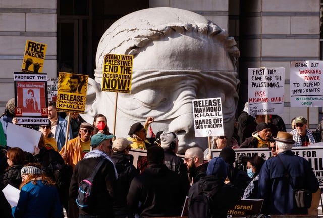 People hold signs as they participate in a protest in support of Columbia University student activist Mahmoud Khalil while a hearing takes place, outside the court in Newark, New Jersey, on March 28, 2025.