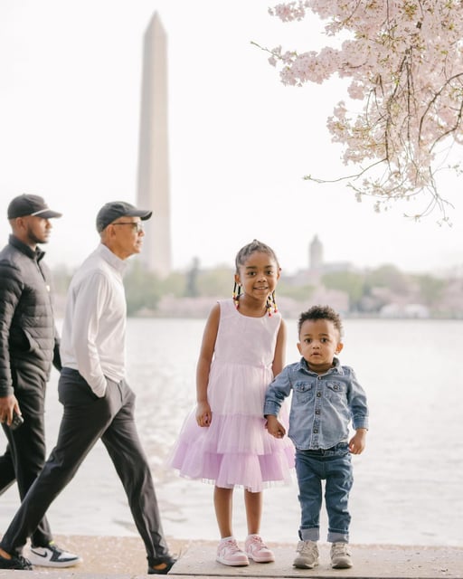 A family taking photos with the cherry blossoms on Washington D.C.s Tidal Basin spotted a famous figure in the background of their shots: former President Barack Obama.