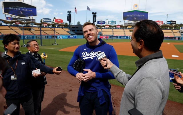 Dodgers first baseman Freddie Freeman speaks to reporters during batting practice before a game against the Atlanta Braves on Tuesday at Dodger Stadium. “Halfway through my morning coffee I was like, ‘Oh, I’ll just shower to get ready for the day’ and next thing I know I’m down in the bathtub,” Freeman said of the “freak accident” that saw him injure his surgically repaired right ankle. (AP Photo/Kevork Djansezian)