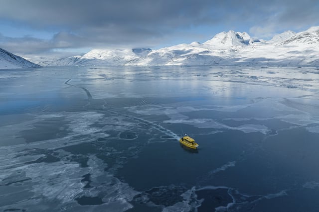 A boat rides through a frozen sea inlet outside of Nuuk, Greenland, March 6, 2025. (AP Photo/Evgeniy Maloletka)