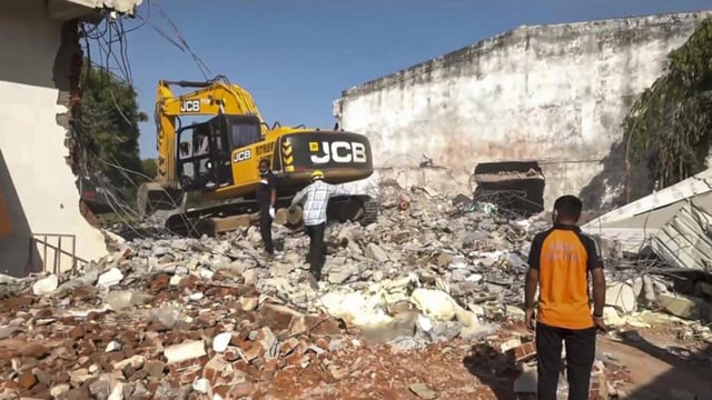 Debris being removed after a massive blaze triggered by a blast raged through a firecracker warehouse in Banaskantha district, Gujarat, on Tuesday. (PTI)