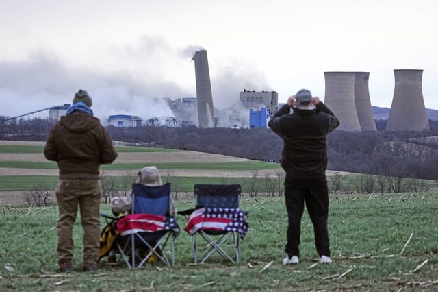 The smokestacks of the former coal-fired Homer City Generating Station crumble in a planned demolition to make way for a new natural gas-fired power plant in Homer City, Pa., Saturday, March 22, 2025. (AP Photo/Gene J. Puskar)