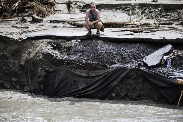 FILE - An overwhelmed resident surveys the damage following flooding caused by the remnants of Hurricane Beryl, July 11, 2024, in Plainfield, Vt. (AP Photo/Dmitry Belyakov, File)