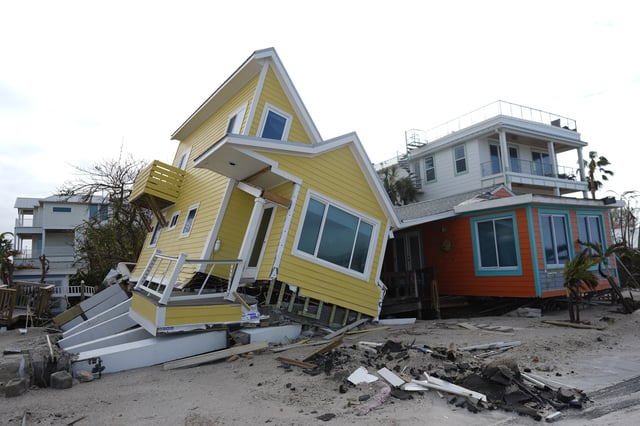 FILE - A house lies toppled off its stilts after the passage of Hurricane Milton, in Bradenton Beach on Anna Maria Island, Fla., Oct. 10, 2024. (AP Photo/Rebecca Blackwell, File)