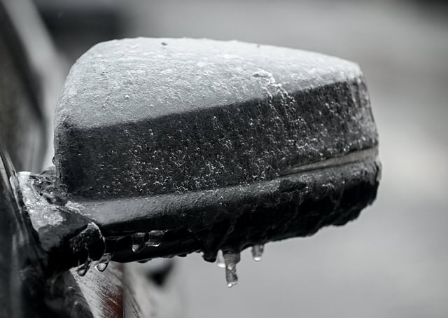 Ice is shown on the side mirror of a car in Montreal, Sunday March 30, 2025, as several hours of freezing rain is forecasted for the area, possibly giving between 5 and 10 millimetres of ice accretion. 