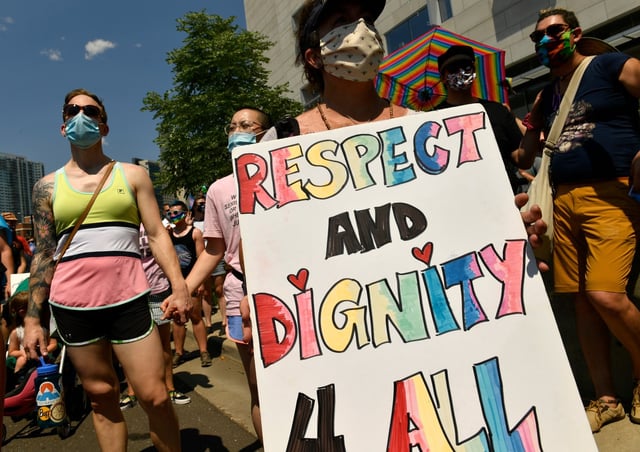 Tracy Selph, center, holds a sign as she and others take part in a rally and march advocating for the rights of transgender people on Aug. 9, 2020, in Denver. (Photo by Helen H. Richardson/The Denver Post)