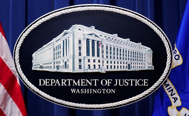 A U.S. Justice Department logo or seal showing Justice Department headquarters, known as "Main Justice," is seen behind the podium in the Department's headquarters briefing room before a news conference in Washington, January 24, 2023.  REUTERS/Kevin Lamarque//File Photo