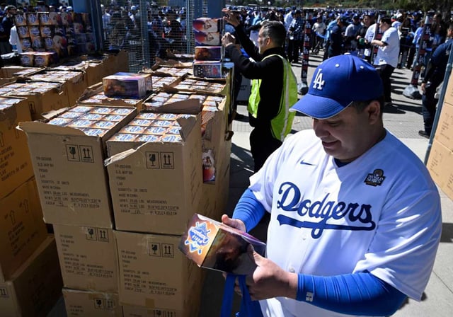 A fan wearing his Dodgers uniform looks over his Shohei Ohtani bobblehead prior to a game between the Dodgers and the Atlanta Braves on Wednesday, April 2, 2025, at Dodger Stadium. (Photo by Keith Birmingham, Orange County Register/SCNG)