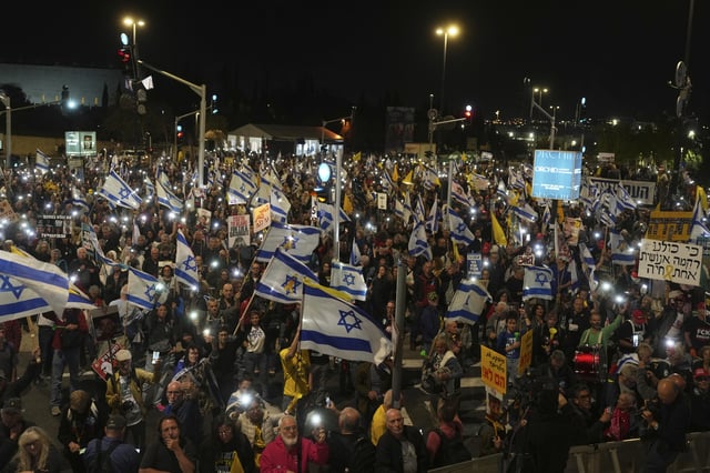 People protest against Prime Minister Benjamin Netanyahu's government outside the Knesset, Israel's parliament in Jerusalem, Monday, March 31, 2025. (AP Photo/Ohad Zwigenberg)