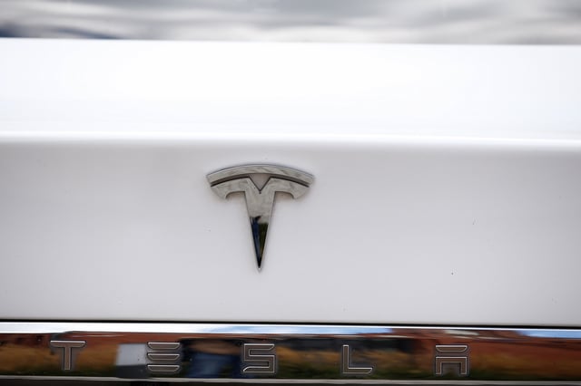 The logo of Tesla cars logo is seen during the presentation of the new charge system in the EUREF campus in Berlin, Germany September 10, 2020. REUTERS/Michele Tantussi/File Photo
