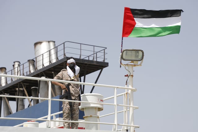 A Houthi soldier stands on board of the Israeli Galaxy ship which was seized by the Houthis, in the port of Saleef, near Hodeidah, Yemen, Sunday, May. 12, 2024.