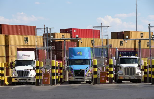 Trucks loaded with shipping containers leave the Port of Montreal in Montreal, Quebec, Canada, May 17, 2021.  REUTERS/Christinne Muschi/File Photo