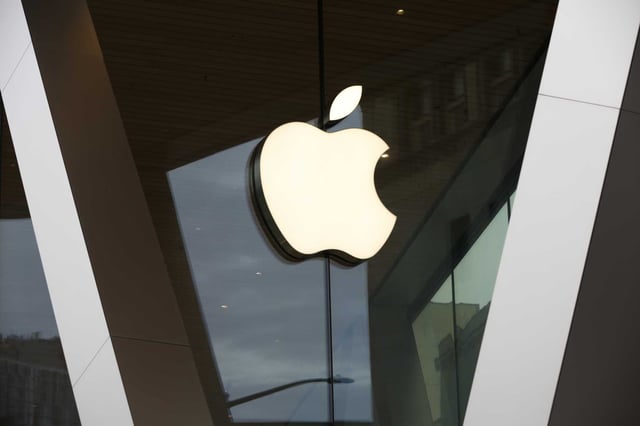 In this Saturday, March 14, 2020, file photo, an Apple logo adorns the facade of the downtown Brooklyn Apple store in New York. 