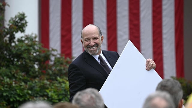 US Secretary of Commerce Howard Lutnick holds a chart as unseen US President Donald Trump delivers remarks on reciprocal tariffs during an event in the Rose Garden entitled Make America Wealthy Again at the White House in Washington, DC, on April 2, 2025. Trump geared up to unveil sweeping new Liberation Day tariffs in a move that threatens to ignite a devastating global trade war. Key US trading partners including the European Union and Britain said they were preparing their responses to Trump's escalation, as nervous markets fell in Europe and America. (Photo by Brendan SMIALOWSKI / AFP)