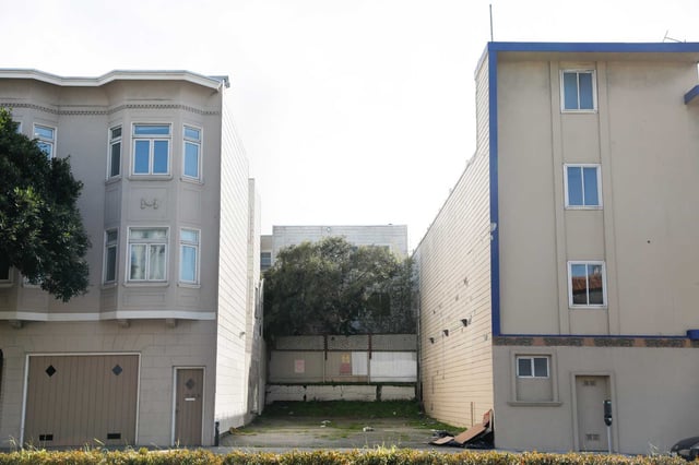 An empty undeveloped lot sits between the Surf Hotel and a residential building on Lombard Street in San Francisco’s  Cow Hollow area. The area could see the rise of eight story buildings, under a new plan for rezoning the city.