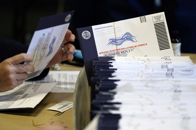 FILE - Chester County, Pa., election workers process mail-in and absentee ballots at West Chester University in West Chester, Pa., Nov. 4, 2020. (AP Photo/Matt Slocum, File)