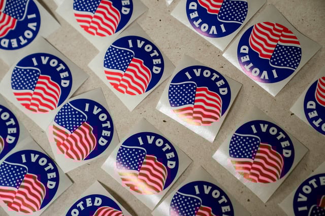 Stickers are lined on a table for voters at the American Legion Post 53 polling location during the Wisconsin Supreme Court election in Eau Claire, Wisconsin, U.S., April 1, 2025.