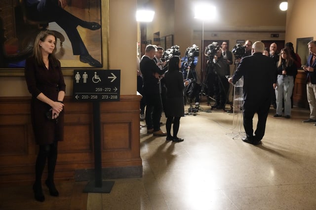 Ontario's Treasury Board President Carolyn Mulroney listens as Premier Doug Ford speaks to the media at the Ontario Legislature, in Toronto, on Wednesday  December 11, 2024. 