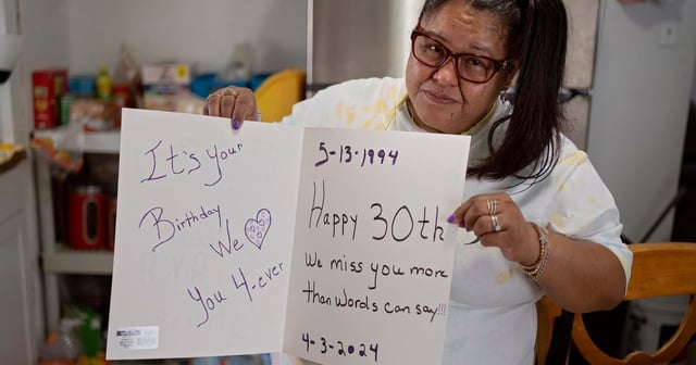 Sarah Knight poses for a portrait at her home in Houston with a birthday card she made for her son Jaleen Anderson on May 13, 2024. Anderson died earlier in the year while being held in LaSalle Correctional Facility in Louisiana.