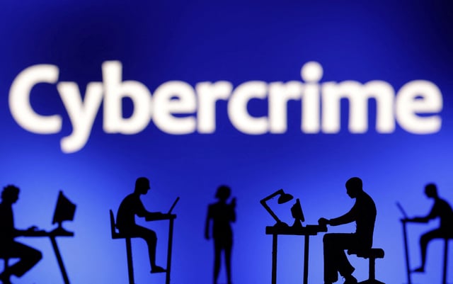 Figurines with computers and smartphones are seen in front the word "Cybercrime" in this illustration taken, February 19, 2024. REUTERS/Dado Ruvic/Illustration/File Photo
