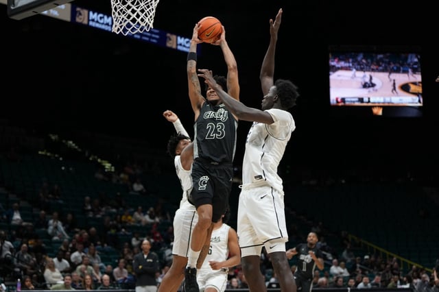 UCF’s Jordan Ivy-Curry and Moustapha Thiam try to defend against Cincinnati’s Dillon Mitchell during the first half of their quarterfinals game in the College Basketball Crown Tournament at the MGM Grand Garden Arena in Las Vegas on Thursday, April 3, 2025. (Omer Khan/FOX Sports)