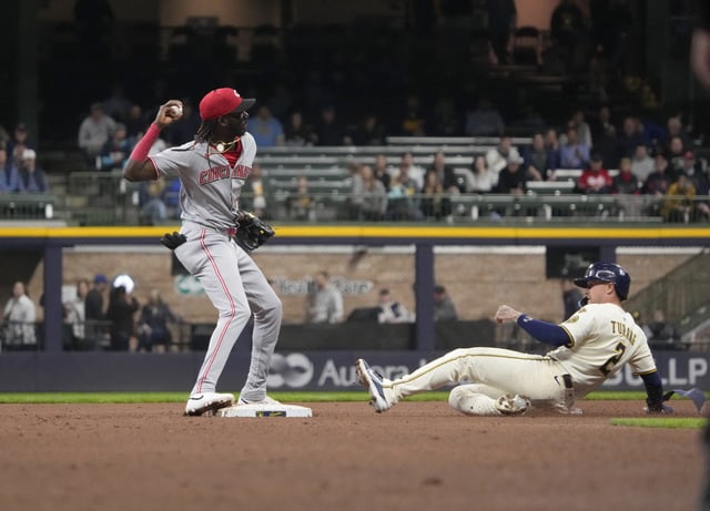 Apr 3, 2025; Milwaukee, Wisconsin, USA; Cincinnati Reds shortstop Elly De La Cruz (44) throws the ball to first base as he forces out Milwaukee Brewers second baseman Brice Turang (2) and completes the double play at American Family Field. Mandatory Credit: Michael McLoone-Imagn Images