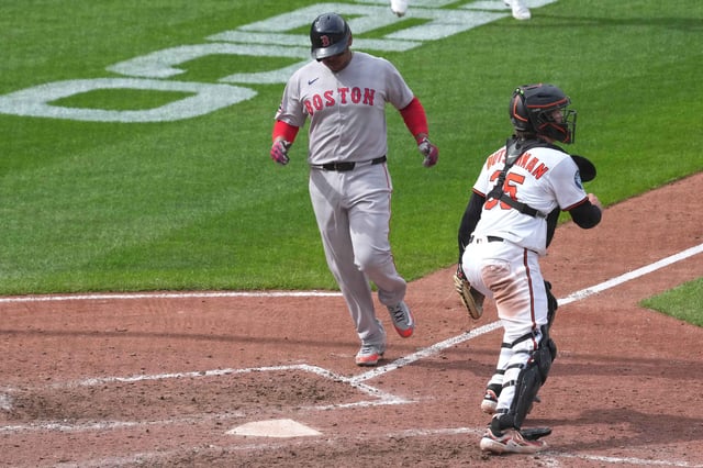 Apr 3, 2025; Baltimore, Maryland, USA; Boston Red Sox designated hitter Rafael Devers (11) scores in the ninth inning against the Baltimore Orioles at Oriole Park at Camden Yards. Mandatory Credit: Mitch Stringer-Imagn Images
