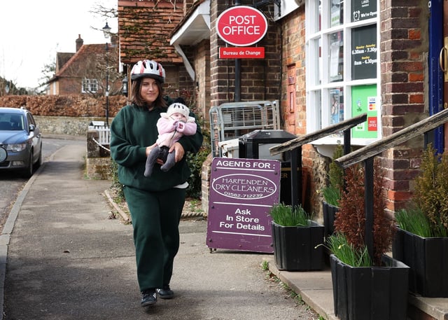 Local resident Vanessa Mariani and her 4-month-old baby Suki wear helmets while shopping, as protection from the hawk.