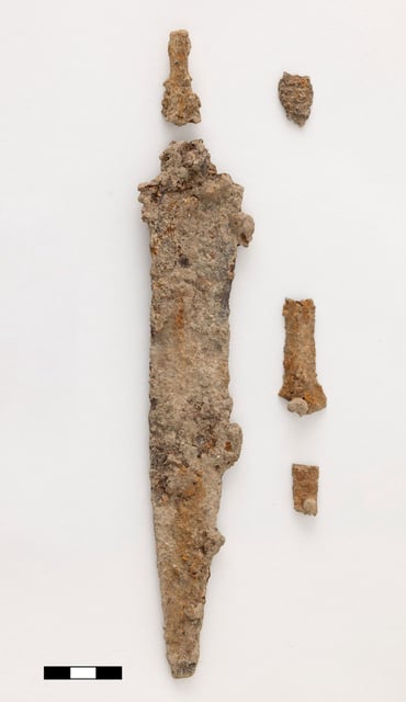 A military dagger was among a small number of objects found in the pit.