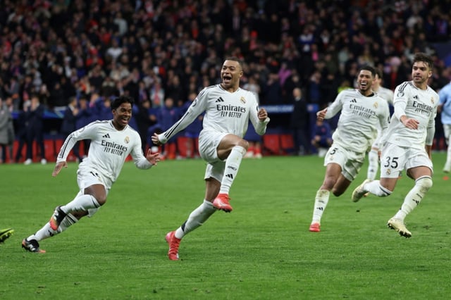 Real Madrid's French forward Kylian Mbappe (C) celebrates with team-mates after the shoot-out win over Atletico Madrid