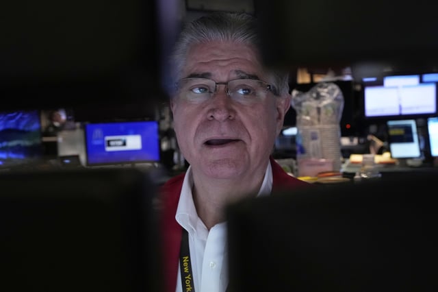 Trader Daniel Kryger works on the floor of the New York Stock Exchange, Friday, April 4, 2025. (AP Photo/Richard Drew)
