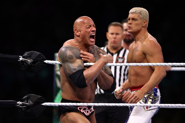 PHILADELPHIA, PENNSYLVANIA - APRIL 06: Dwayne &#34;The Rock&#34; Johnson reacts during a tag team fight with Roman Reigns against Cody Rhodes and Seth &#34;Freakin&#34; Rollins during Night One of WrestleMania 40 at Lincoln Financial Field on April 06, 2024 in Philadelphia, Pennsylvania.