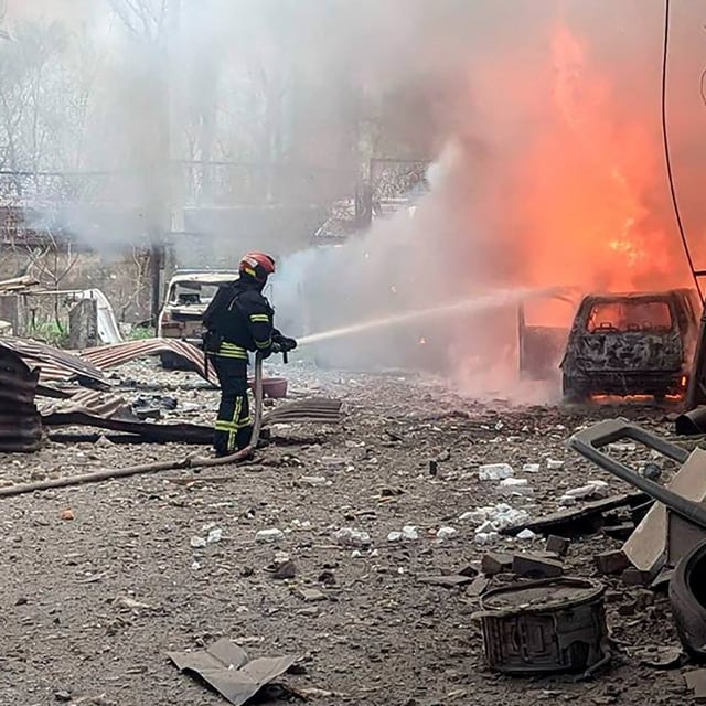 In this handout photograph taken and released by the Ukrainian Emergency Service in Kryvyi Rig on April 2, 2025, Ukrainian rescuers work to extinguish a fire at the site of a missile attack, amid the Russian invasion of Ukraine. A Russian ballistic missile strike killed at least four people and wounded 17 others in Ukrainian President's home city of Kryvyi Rig on April 2, 2025 authorities said. (Photo by Handout / UKRAINIAN EMERGENCY SERVICE / AFP) / RESTRICTED TO EDITORIAL USE - MANDATORY CREDIT "AFP PHOTO / UKRAINIAN EMERGENCY SERVICE" - NO MARKETING NO ADVERTISING CAMPAIGNS - DISTRIBUTED AS A SERVICE TO CLIENTS (Photo by HANDOUT/UKRAINIAN EMERGENCY SERVICE/AFP via Getty Images)