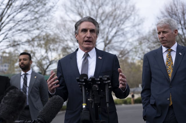 Interior Secretary Doug Burgum, center, and Energy Secretary Chris Wright, right, speak to reporters at the White House in Washington, Wednesday, March 19, 2025. (AP Photo/Ben Curtis)