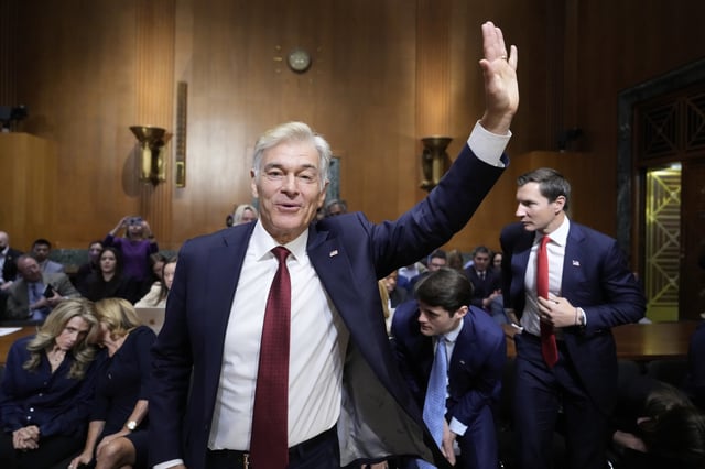 Dr. Mehmet Oz, President Donald Trump's pick to lead the Centers for Medicare and Medicaid Services, waves at the conclusion of his confirmation hearing before the Senate Finance Committee, on Capitol Hill in Washington, Friday, March 14, 2025. (AP Photo/Ben Curtis)