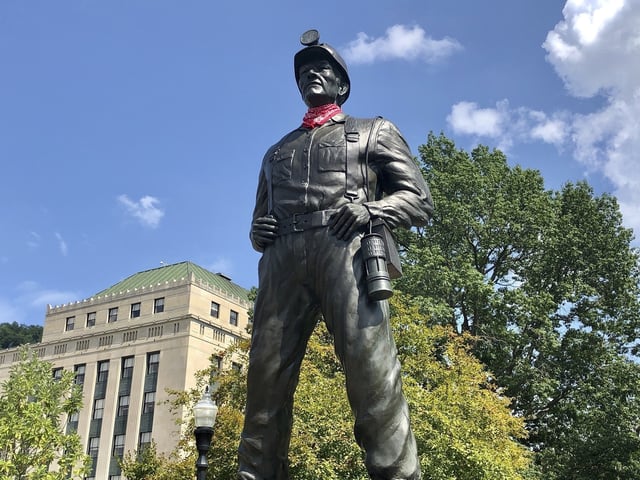 FILE - A statue of a coal miner stands at the West Virginia Capitol in Charleston, W.Va., Aug. 26, 2021. (AP Photo/John Raby, File)