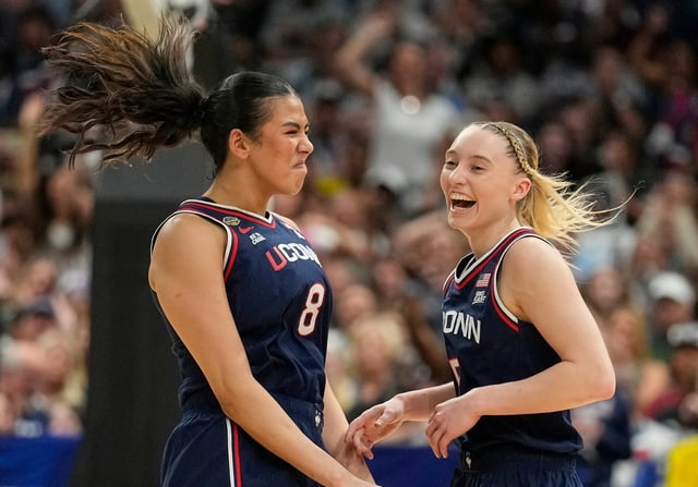 UConn center Jana El Alfy (8) and UConn guard Paige Bueckers (5) react during the first half of a national semifinal Final Four game against UCLA during the women’s NCAA college basketball tournament, Friday, April 4, 2025, in Tampa, Fla. (AP Photo/Chris O’Meara)