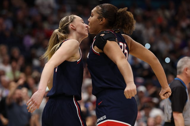 Connecticut guard Paige Bueckers (5) and forward Ice Brady (25) react during the third quarter of their women's Final Four game against UCLA at Amalie Arena in Tampa, Florida on April 4, 2025.