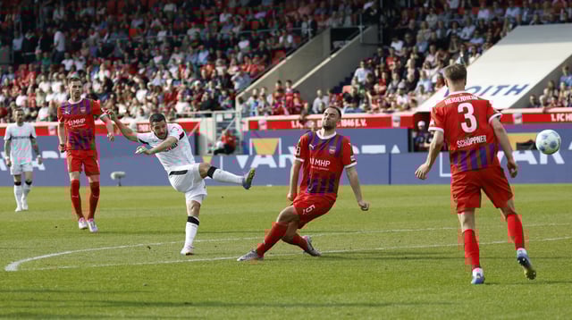Soccer Football - Bundesliga - 1. FC Heidenheim v Bayer Leverkusen - Voith-Arena, Heidenheim, Germany - April 5, 2025 Bayer Leverkusen's Emiliano Buendia scores their first goal REUTERS/Heiko Becker