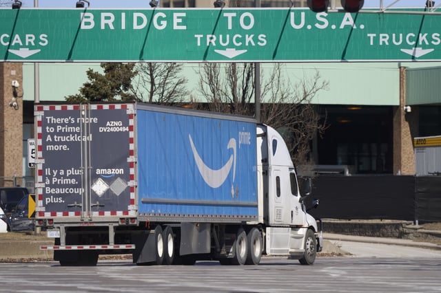 Trucks prepare to cross the US-Canada border at the Ambassador Bridge in Windsor, Ontario, on March 8, 2025.