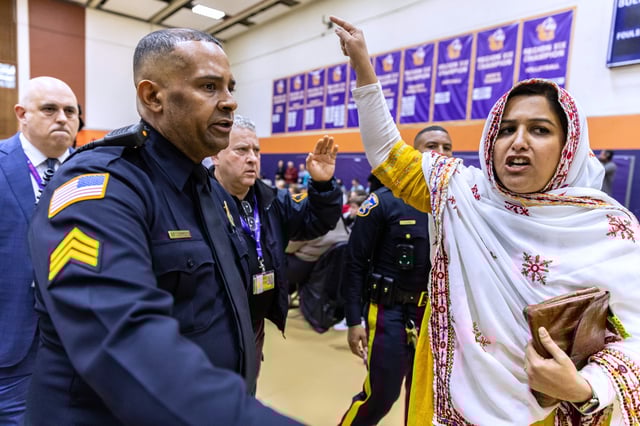 A person disrupts a town hall event with Sen. Cory Booker, D-N.J., (not pictured) held at the Bergen Community College in Paramus, N.J., on on Saturday, April 5, 2025. (AP Photo/Stefan Jeremiah)