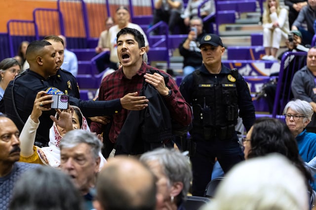 A person disrupts a town hall event with Sen. Cory Booker, D-N.J., (not pictured) held at the Bergen Community College in Paramus, N.J., on on Saturday, April 5, 2025. (AP Photo/Stefan Jeremiah)