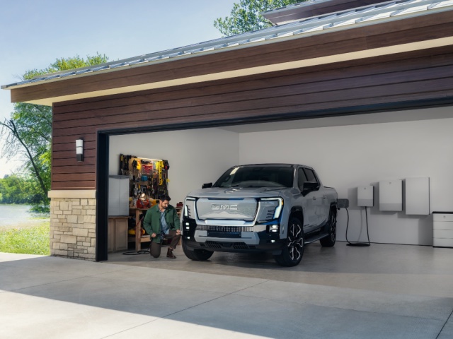 GM electric vehicles and stationary storage systems are now eligible to participate in EnergyHub utility grid programs for EVs and home energy storage. Pictured: a GMC Sierra EV Denali pickup truck and PowerBank stationary storage system.