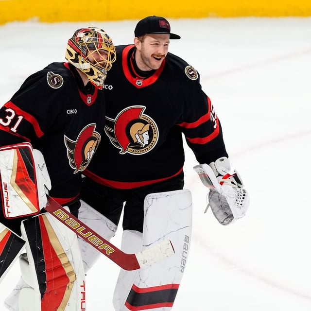 Ottawa Senators goaltender Anton Forsberg (31) celebrates his shutout against the fellow goaltender Linus Ullmark (35) after third period NHL hockey action in Ottawa, on Saturday, April 5, 2025. THE CANADIAN PRESS/Justin Tang