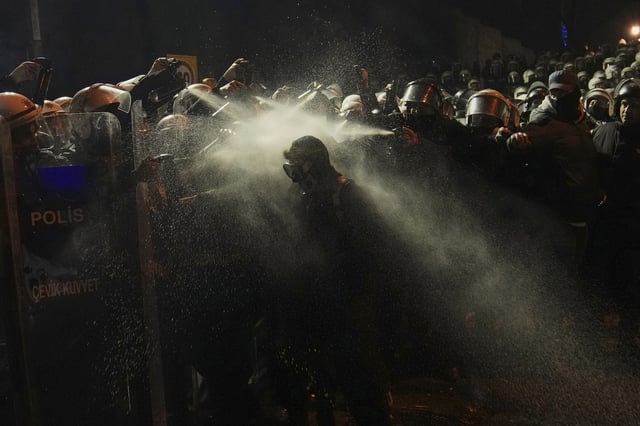FILE - Riot police use pepper spray to clear a protester during a protest against the arrest of Istanbul's Mayor Ekrem Imamoglu, in Istanbul, Turkey, Saturday, March 22, 2025. (AP Photo/Khalil Hamra, File)