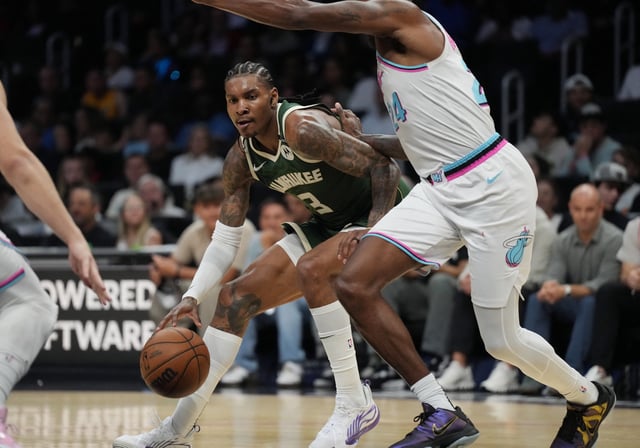 Apr 5, 2025; Miami, Florida, USA;  Milwaukee Bucks guard Kevin Porter Jr. (3) looks for space as Miami Heat forward Haywood Highsmith (24) defends during the second half at Kaseya Center. Mandatory Credit: Jim Rassol-Imagn Images