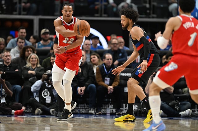 Apr 5, 2025; Detroit, Michigan, USA;  Memphis Grizzlies guard Desmond Bane (22) passes the ball past Detroit Pistons guard Cade Cunningham (2) to teammate Scotty Pippen Jr. (1) in the first quarter at Little Caesars Arena. Mandatory Credit: Lon Horwedel-Imagn Images