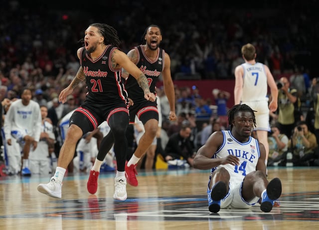 Houston's Emanuel Sharp (21) and J'Wan Roberts celebrate after their comeback win against Duke on Saturday night at the Alamodome.